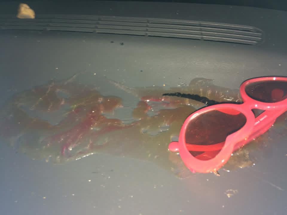 Melted candy spill dried onto a car dashboard