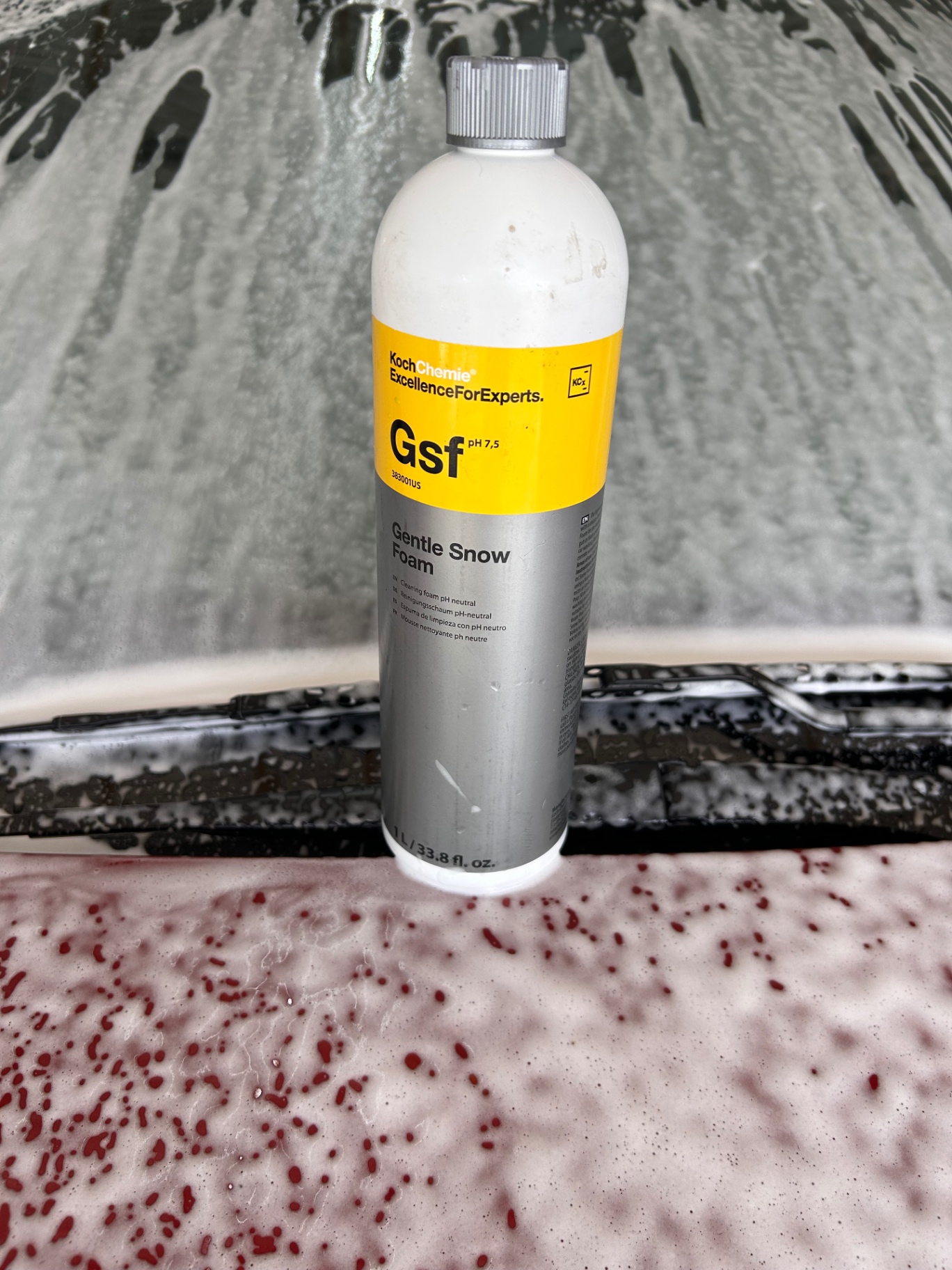 Koch Chemie Gentle Snow Foam bottle on a foamed hood