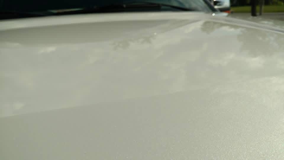 Close-up of a dull, hazy white car hood
