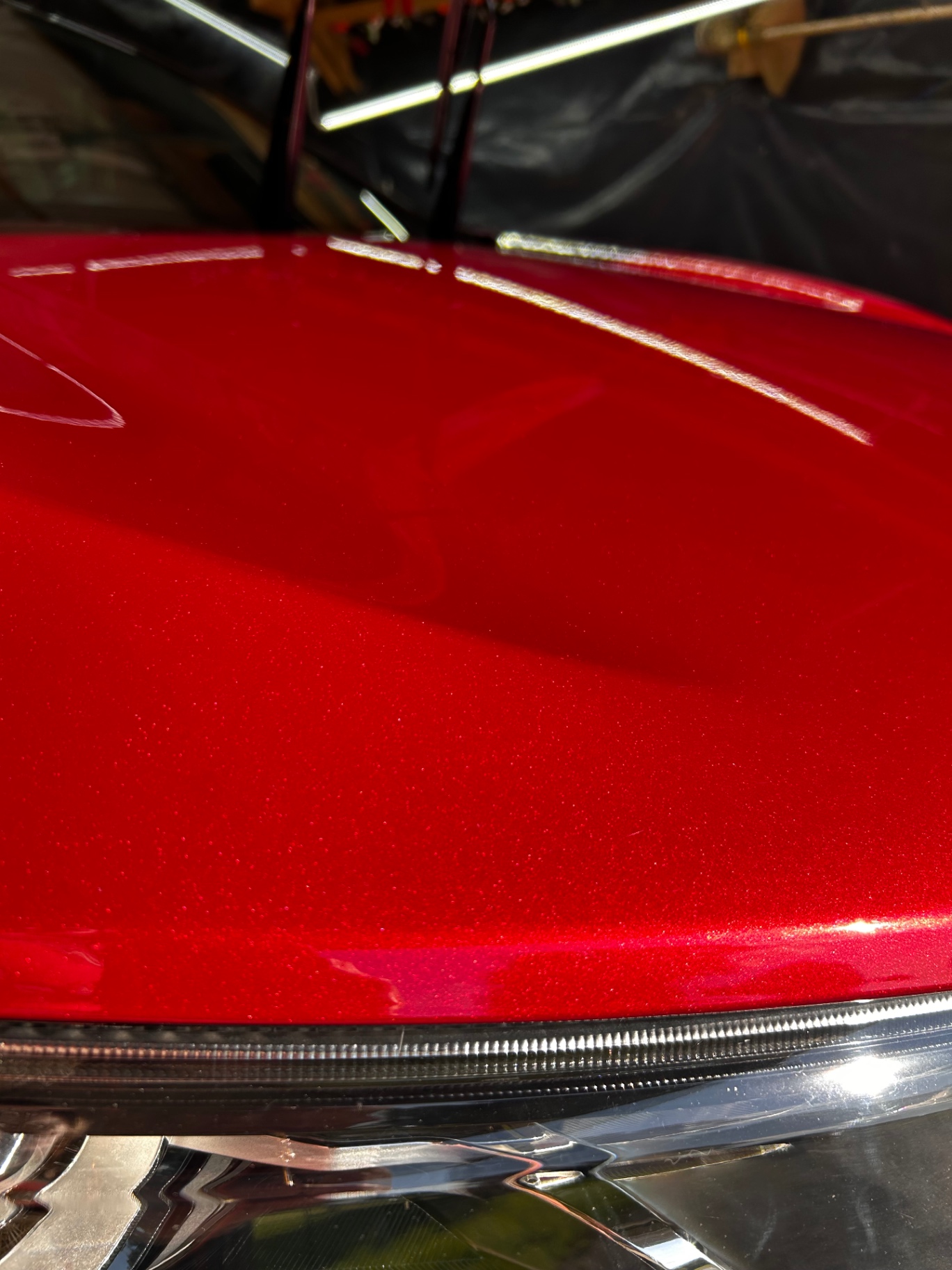 Metallic red paint with restored gloss above the headlight
