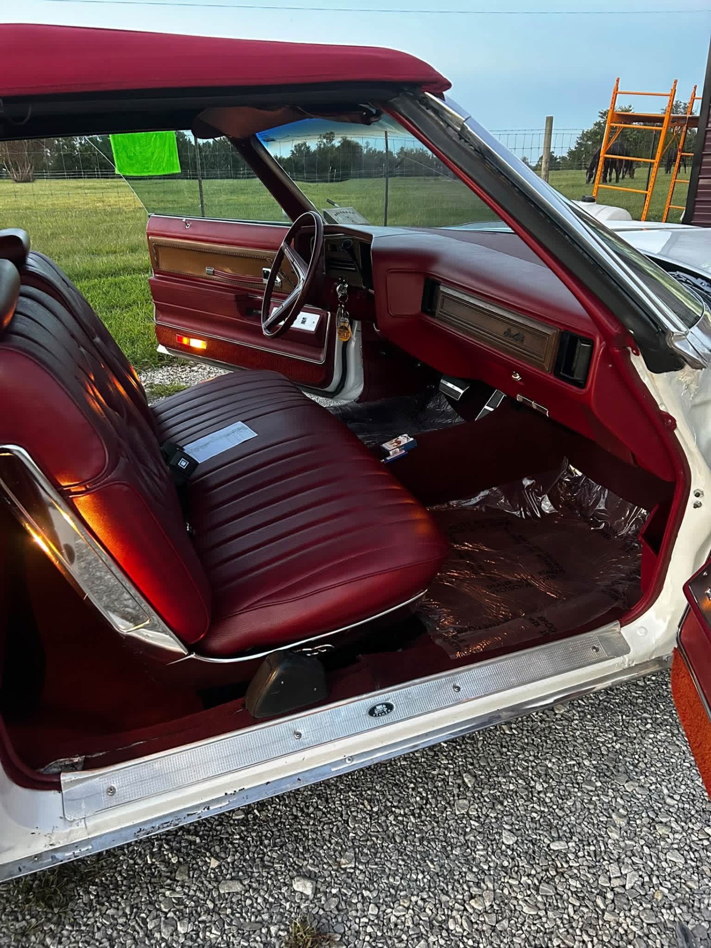 Red leather interior and wood trim of a classic convertible after detailing