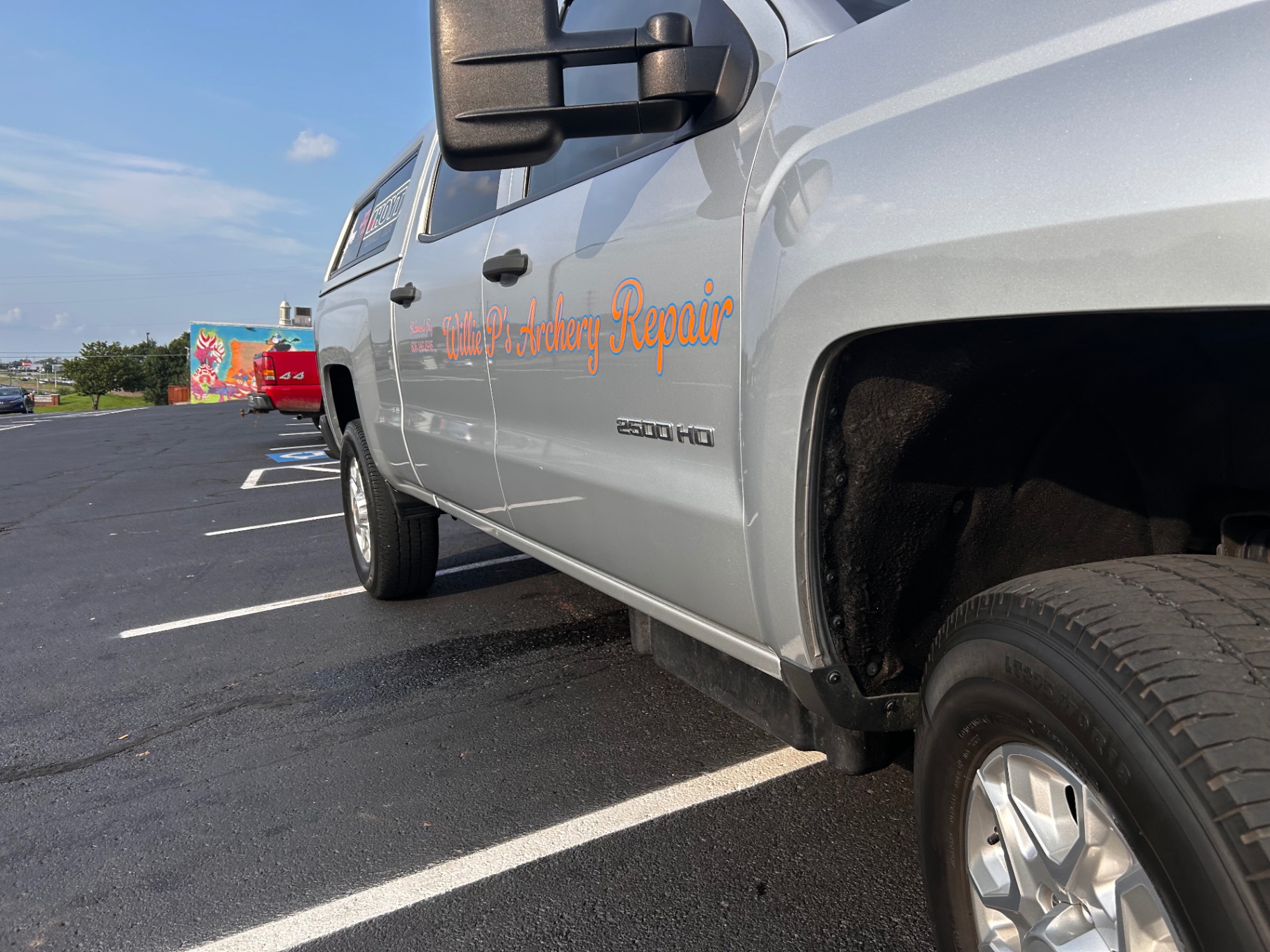 Close-up of a detailed silver truck door and wheel