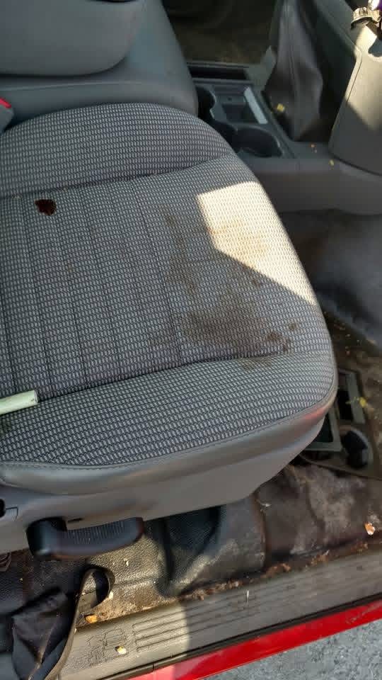 Dirty stained cloth truck seat before interior detailing