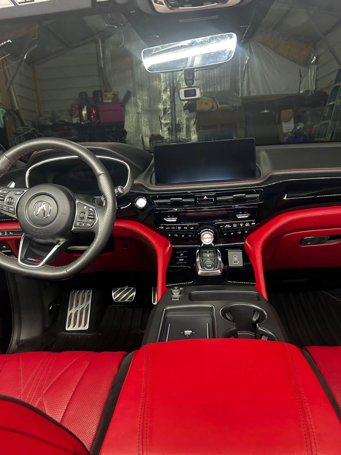 Black and red Acura interior with cleaned dash, screen and steering wheel