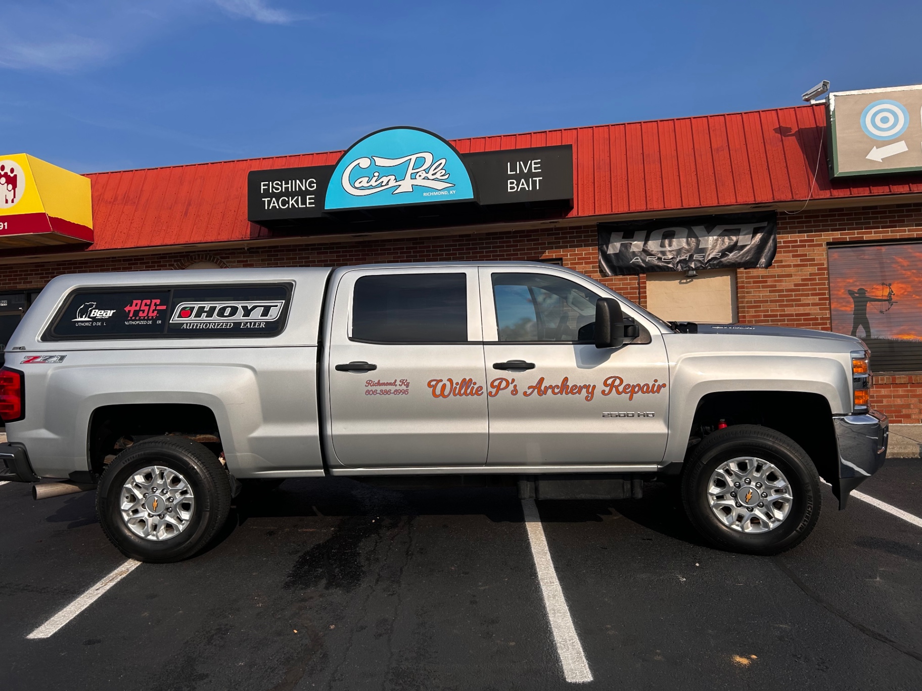 Silver Chevrolet Silverado with graphics parked after detailing
