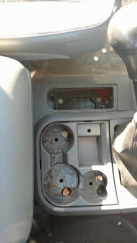 Dirty truck center console and cup holders before cleaning