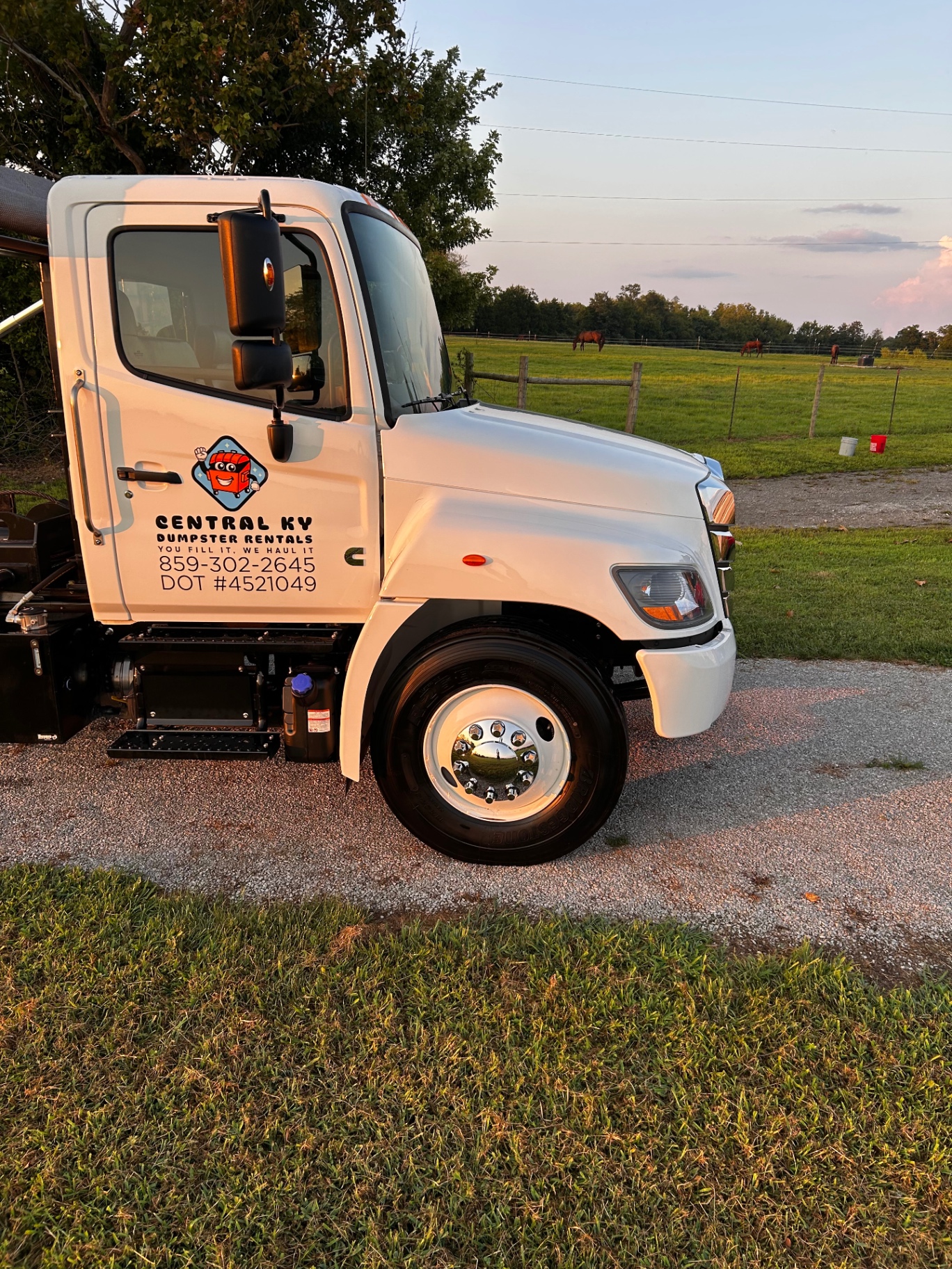 Clean white Hino truck door with Central KY Dumpster Rentals graphics