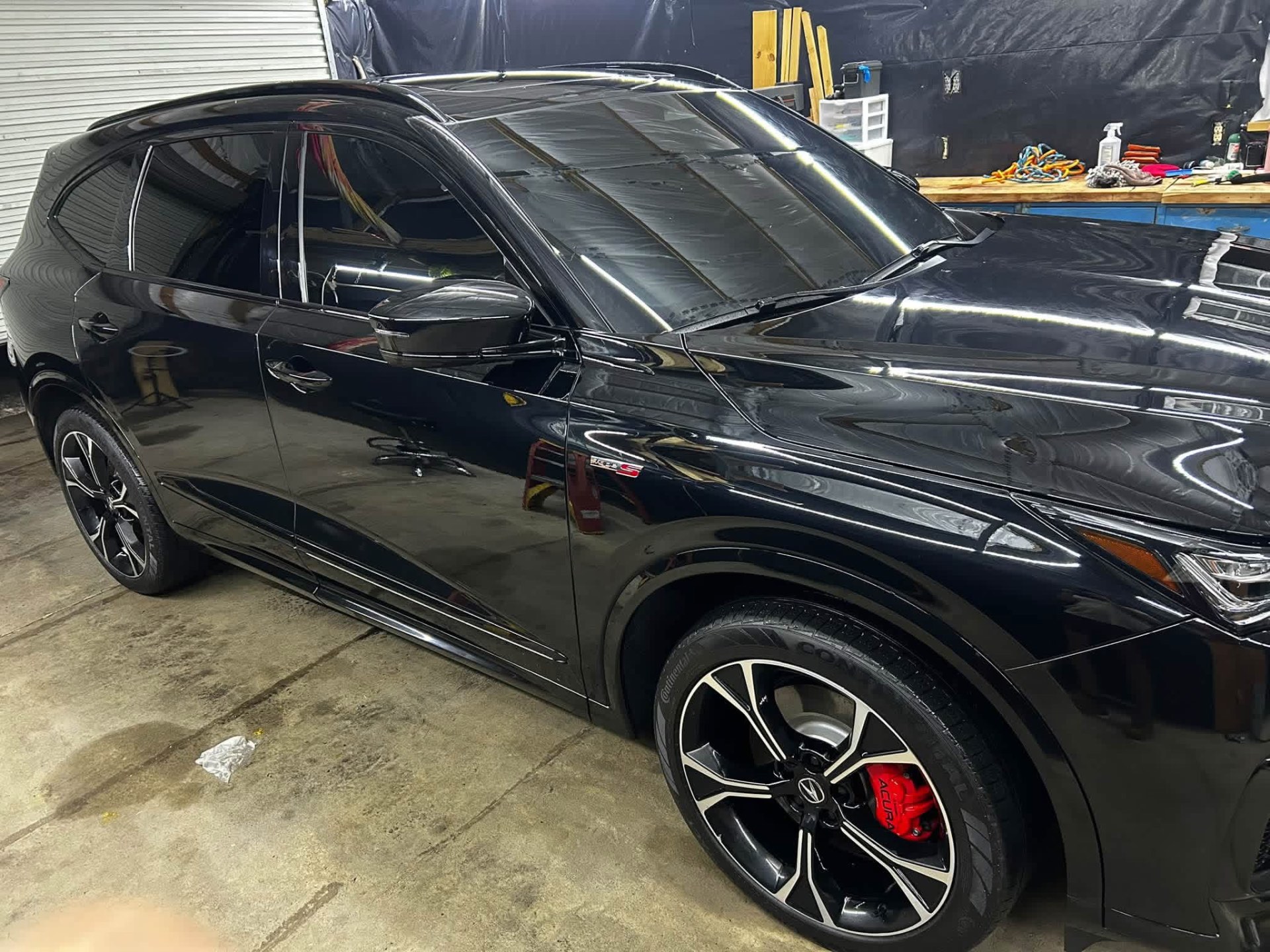 Black Acura MDX Type S with glossy detailed paint in the shop