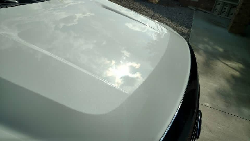 White car hood with a mirror-like detailed finish