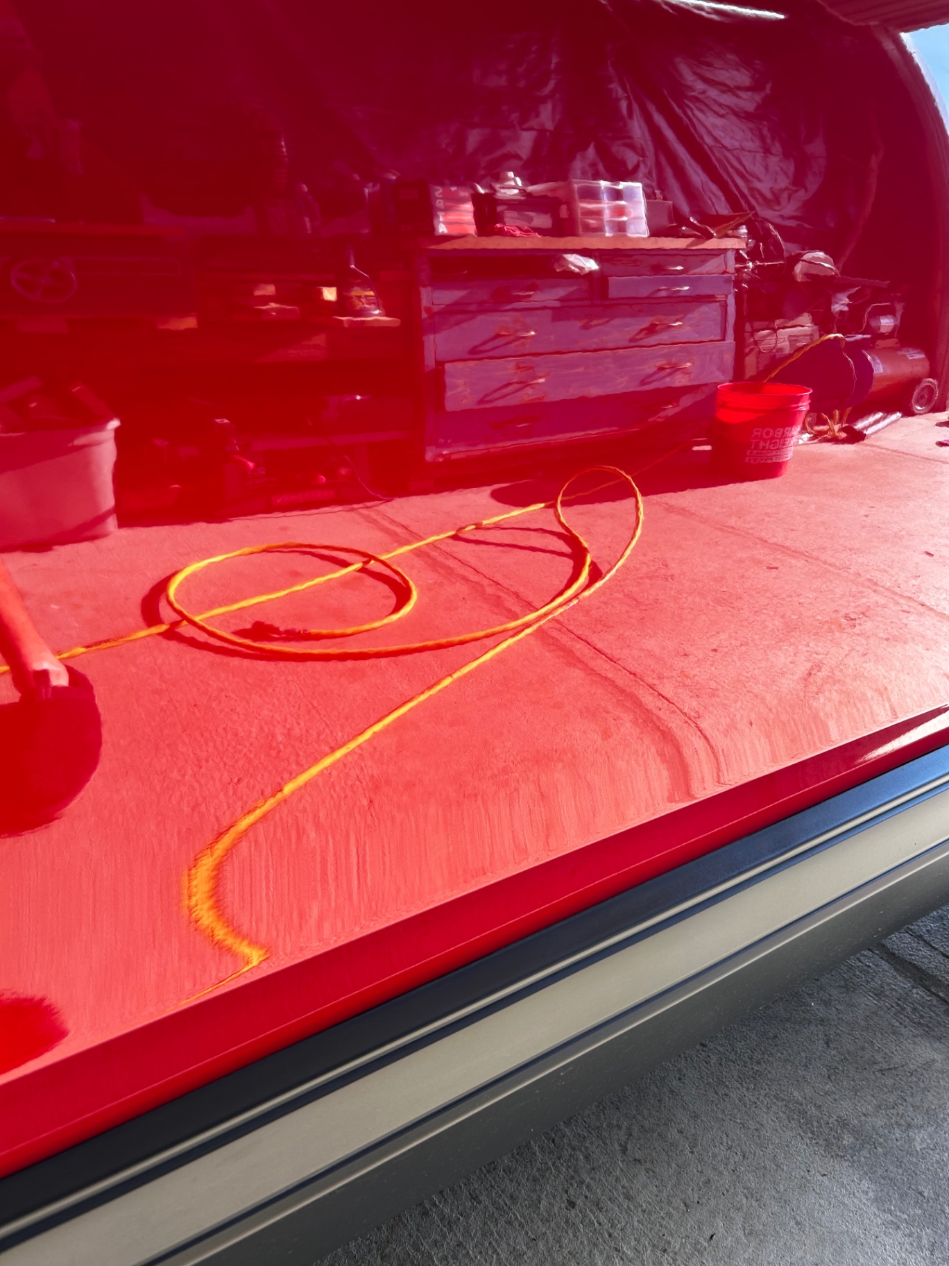Deep gloss reflection on a freshly detailed red hood